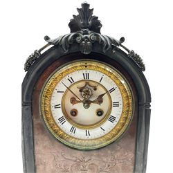 A late 19th century Belgium slate mantle clock with carved applied decoration to the arched top, on a shaped rectangular plinth raised on four paw feet, with a centre panel in contrasting pink marble with incised decoration, two part contrasting white enamel dial with Roman numerals and minute markers, steel spade hands and visible Brocot escapement, dial within a cast brass bezel with a flat bevelled glass, eight-day Parisian striking movement, striking the hours and half hours on a bell.  With pendulum. 

