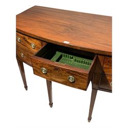 19th century mahogany bowfront sideboard fitted with central frieze drawer flanked by a deep cellaret drawer and a cupboard door, with faux drawer fronts, raised on square tapering legs with spade feet
