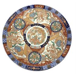 Large Japanese Meiji Period charger, decorated in the Imari palette with Dragons chasing the flaming pearl, roundels and foliate decoration, D46cm