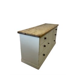 Victorian dresser base, the sycamore top over painted pine base with one central cupboard flanked by three graduated drawers, raised on a plinth base 