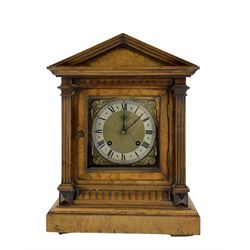 German - late 19th century 8-day Walnut mantle clock, with a gable pediment and reeded columns to the dial, with a broad plinth and block feet, brass dial with cherub spandrels, matted dial centre, silver chapter and steel hands, two train quarter striking movement, striking on two coiled gongs. With pendulum and key.