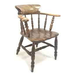 Victorian elm and ash smokers bow armchair, arm rests raised on spindle gallery over shaped saddle seat, raised on turned supports with double 'H' stretcher W68cm