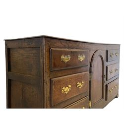 18th century and later oak dresser base, with one central cupboard opening to reveal two fixed shelves, flanked by six graduated drawers, raised on bracket feet 