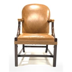 Late 19th/ Early 20th century mahogany Gainsborough style library chair, upholstered in studded tan leather, raised on square chamfered front supports with double 'H' stretcher W64cm