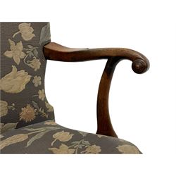 George II walnut elbow chair, upholstered in floral pattern fabric, shaped arms with scrolled terminals, plain seat rail with drop-in seat cushion, on cabriole supports with c-srcoll carved brackets