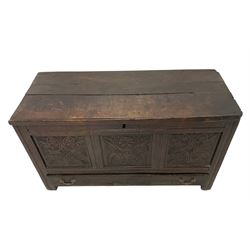 18th century oak coffer or mule chest, rectangular hinged top concealing compartment and candle box, the three front panels carved with stylised acanthus leaves and foliate decoration, the base fitted with single drawer with carved decoration, raised on stile feet