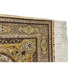 Fine silk Persian Hereke rug, the mihrab enclosing intricate floral design with urn, the main border band decorated with multiple shaped panels decorated with flowers, with signature panel 