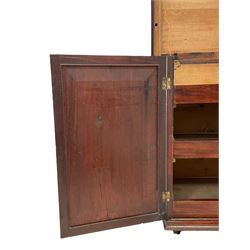 Georgian rosewood and mahogany linen press, the moulded rectangular top with lozenge band and crossbanding, two panelled doors with segmented and oval veneers, the interior fitted with three linen slides, lower moulded edge, on brass castors