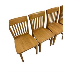 Set four light beech dining chairs, the slatted back over seat, raised on square supports united by stretchers 