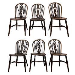 Early 19th century harlequin set of six elm and beech Windsor chairs, hoop and stick back with pierced wheel splat, on dished saddle seats, turned supports joined by swell turned stretchers, two stamped on rear 