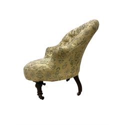 Victorian mahogany framed tub armchair, buttoned back and sprung seat upholstered in pale yellow ground foliate fabric, on turned front supports with castors