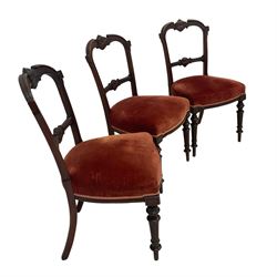 Set three late 19th century dining chairs, cresting rail carved with c-scrolls and Greek key design, middle rail with central foliate motif and extending scrolling, upholstered sprung seat raised on fluted turned supports 