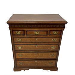 Early 19th century oak chest, rectangular mahogany crossbanded top with moulded edge, over dentilled cornice and blind fretwork frieze drawer, fitted with three short drawers over three long graduating drawers, each with mahogany crossbanding and ebony and satinwood stringing, flanked by fluted pilaster columns, raised on shaped bracket feet