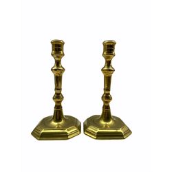 Pair of 18th century brass candlesticks with fluted and baluster knop stems and octagonal bases H20cm