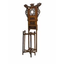 Chinese hardwood hall stand, the raised back surmounted by ho-ho birds and carved with pierced floral fretwork and relief carved panels, four division umbrella stand, turned front supports 
