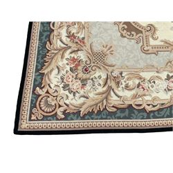 French Aubusson ivory ground carpet, the central floral bouquet medallion surrounded by a rose garland and a shaped foliate band with scrolling acanthus leaves and cartouche motifs, the border decorated with repeating rinceaux decoration, the corners with spayed acanthus leaves and scallop shell motifs, the exterior teal band with an outer egg and dart edge
Provenance: From the Estate of the late Dowager Lady St Oswald