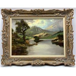 Jack M. Ducker (Scottish fl.1910-30): Fishing in a Loch, Scottish Highland landscape oil on board, signed 38cm x 53cm