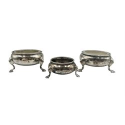 George II silver circular salt on triple shaped supports London 1740, maker Edward Wood, another by the same maker and a single Victorian bead edge salt by Robert Harper 