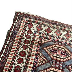 Persian pale blue ground rug, the field decorated with two rows of interconnected lozenge motifs, the multi-band border decorated with geometric patterns 