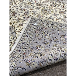 Persian ivory ground rug, central star motif enclosed by interlaced foliate, with multi line border,  270cm x 198cm