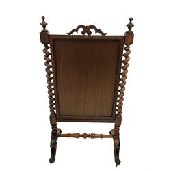 20th century mahogany fire screen, the central panel with equestrian design, flanked by two spiral turned columns, terminating in brass castors  