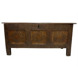18th century oak blanket box, rectangular hinged top, frieze carved with lunettes, the three front panels decorated with lozenges, flanking uprights with stylised acanthus leaves, raised on stile supports