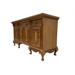 Early 20th century walnut sideboard, rectangular top over reeded frieze, fitted with three drawers and four panelled cupboards, fluted uprights with foliate capitals, apron carved with central shell and extending acanthus carving, raised on cabriole supports with pad feed 