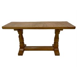 Mouseman - oak coffee table, rectangular adzed top, octagonal pillar supports on sledge feet united by floor stretcher, carved with mouse signature, by the workshop of Robert Thompson, Kilburn 