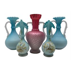 Pair of blue satin glass vases of bottle form with frilled, flared rims and branch work handles, pair of small jugs with painted decoration and frilled rims together with another pink quilted twin handled vase max H26cm