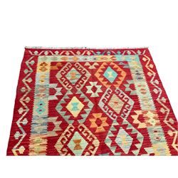 Anatolian Turkish Kilim red ground rug, the field with two columns of geometric lozenges, enclosed in a border of repeating geometric patterns