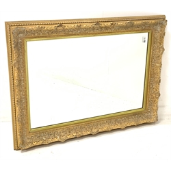 20th century wall mirror in floral moulded gilt frame 