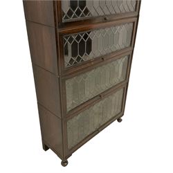 Globe Wernicke design oak stacking library bookcase, four tiers with lead glazed up-and-over doors, on cabriole feet