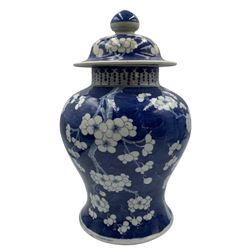 20th century Chinese prunus pattern jar & cover decorated in blue and white H29cm and a blue and white Japanese vase with birds and flowering branches H26cm (2)