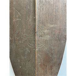 Oceanic paddle club with incised floral design, the reverse with a heart and initials and carved fishtail handle L137cm
