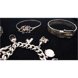 Silver jewellery including curb link bracelet with heart locket clasp and eleven charms including poodle, cherub and three wise monkeys, dragon design bangle, bright cut buckle bangle and one other hinged bangle 