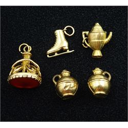 9ct gold carnelian fob pendant and four 9ct gold charms including ice skates, bottle and teapot, all hallmarked