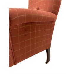 Edwardian armchair upholstered in later fabric, terminating in ceramic castors 