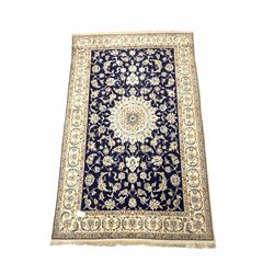 Persian Nain design ground rug, the blue field with floral medallion on blue field with interlaced trailing foliate, bordered and signed 205cm x 124cm