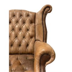 Georgian design hardwood framed wingback armchair, upholstered in buttoned and stitched tan leather with stud work detail, on cabriole feet