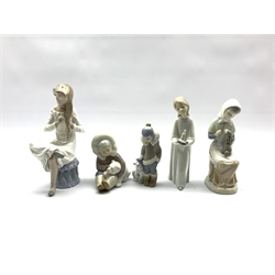 Two Lladro figures of Eskimo children with polar bear cubs, Nao figure of a girl brushing her hair and two other figures