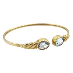 9ct gold two stone blue topaz torque bangle, stamped 375