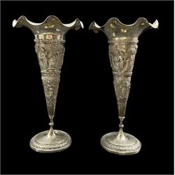 Pair of Indian White Metal trumpet shape vases with embossed decoration of figures and landscapes marked 90 H23cm