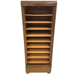 Early 20th century vintage filing cabinet, the tambour falling front opening to reveal adjustable shelves, raised on square supports W44cm, H115cm. D36cm
