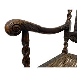 Late 19th century Carolean style oak open armchair, the cresting rail carved with pierced crown and scrolled foliage, cane work back and seat, spiral turned upright supports with moulded arms, turned and block supports joined by bobbin turned stretchers; together with a similar period Carolean style oak open armchair, the cresting rail carved and pierced with scrolling foliage and central shell motif, the arms carved with acanthus leaves, cane work seat and back, on spiral turned and block supports and stretchers 