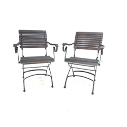 Pair of stained slatted hardwood and wrought metal folding garden chairs 