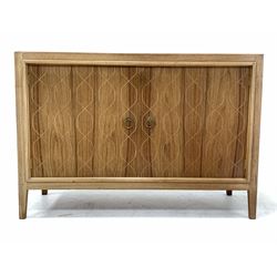 Gordon Russell - Mid 20th century teak 'Double Helix' sideboard, the front with double doors opening to reveal a shaped shelf and drawer, raised on square tapered supports, bearing 'Russell of Broadway' label to reverse W122cm, H84cm, D46cm