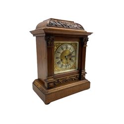 A German mantle clock in an oak case manufactured by HAC (Hamburg American Clock Company) c 1890, basket top with Arts and craft carving on a tooled background, square brass dial flanked by two reeded pillars with Corinthian capitals on a deep pediment raise on four bun feet, dial with spandrels and silvered chapter ring with Roman numerals, half hour markers, minute track and steel fleur di Lis hands, eight day striking movement striking the hours and half-hours on a coiled gong. With pendulum.









