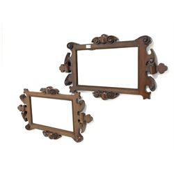 Pair of 19th century mahogany framed landscape wall hanging mirrors, shaped and scroll carved frame enclosing bevel edged mirror, (W82cm, H44cm)