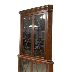 19th century mahogany floor standing corner cabinet, projecting moulded cornice over four astragal glazed doors, on bracket feet