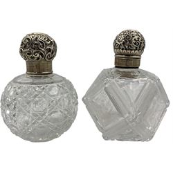 Late Victorian glass scent flask of facetted design and etched with flowers, embossed silver cover Birmingham 1893 Maker Hilliard & Thomason and an Edwardian glass globe scent flask with silver cover Birmingham 1905 Maker Britton Gould & Co (2) 